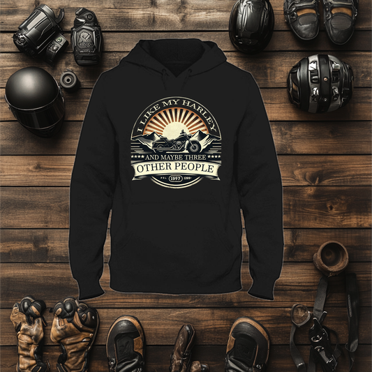 A mock up for a biker hoodie with a classic style. On The Hoodie there is a Harley Davidson Looking Bike With A Vintage Style Sunset And Mountains With The Wording " I Like My Harley And Maybe Three  Other People".