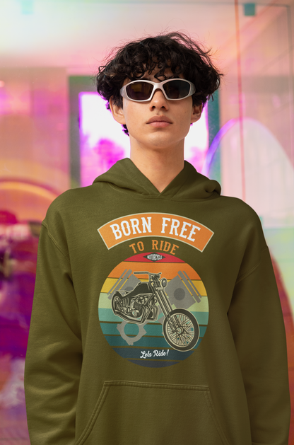 A young lad were sunglasses and sporting a biker hoodie in green with a colourful backdrop.