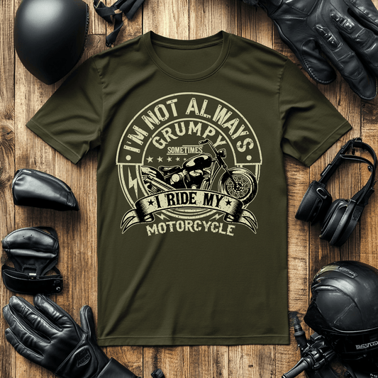 A mock-up for a biker T-shirt saying “I’m not always grumpy” the tee is surrounded by motorcycle apparel like gloves helmet.